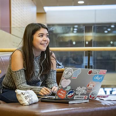 A student works on her laptop in the A. W. Clausen Center for World Business.