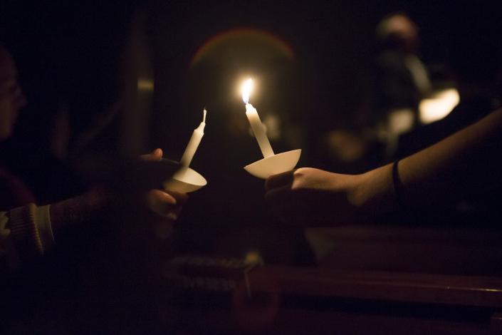 Concert-goers at the annual Carthage Christmas Festival participate in the Service of Light in Si...